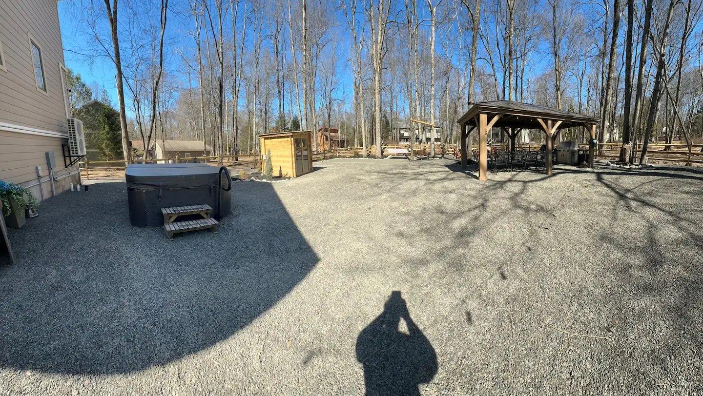 Panoramic backyard view with hot tub and steps, cedar sauna cabin, and gazebo dining pavilion
